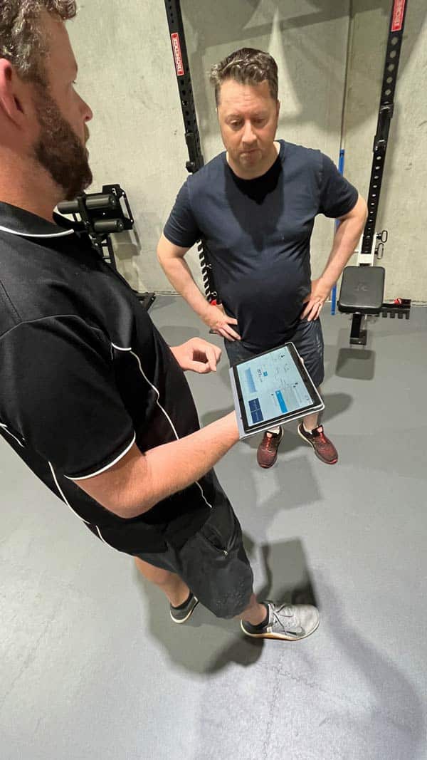 Trainer explaining to client about fitness assessment